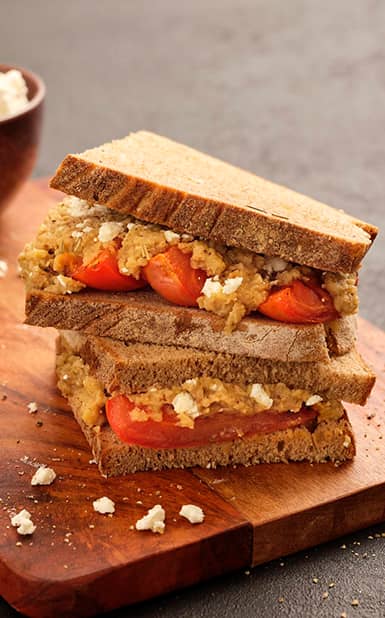 Sanduíche de beringela assada, tomate grelhado e queijo feta